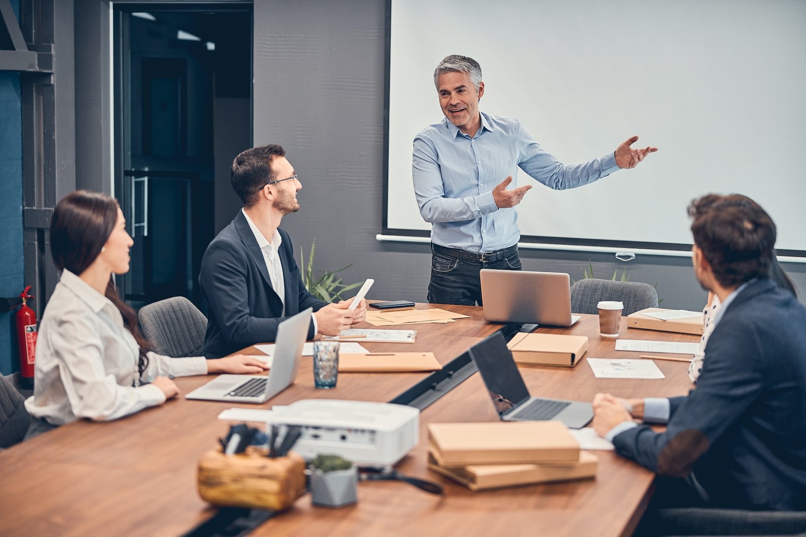 managers-discussing-new-startup-project-with-boss-in-office.jpg